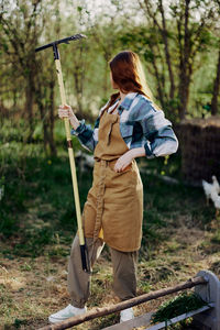 Rear view of woman standing on field