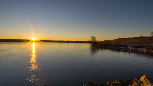 Scenic view of lake at sunset