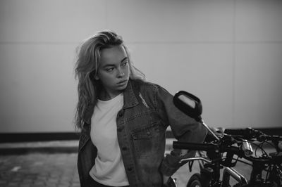 Woman standing by bicycle at basement