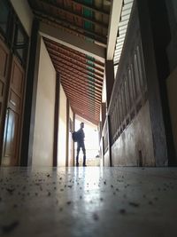 Rear view of man walking in building