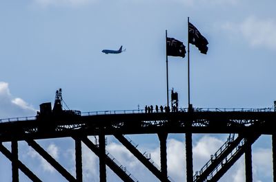 Low angle view of silhouette bridge against sky