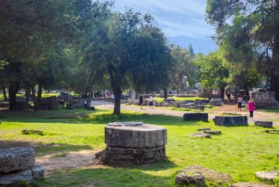 Trees in cemetery against sky