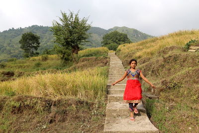 Full length of woman on landscape against mountain