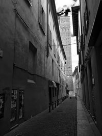 Road amidst city against sky