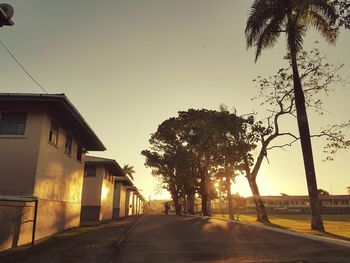 Street amidst trees against clear sky