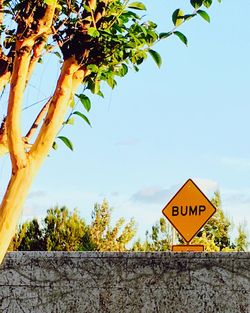 Close-up of road sign against sky