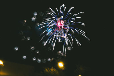 Low angle view of firework display at night