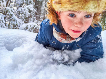 Portrait of young woman standing on snow