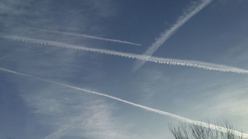 Low angle view of vapor trail in blue sky