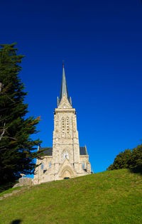 Low angle view of building against clear blue sky