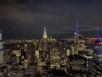 Illuminated cityscape against sky at night