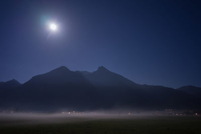 Scenic view of mountains against sky at night