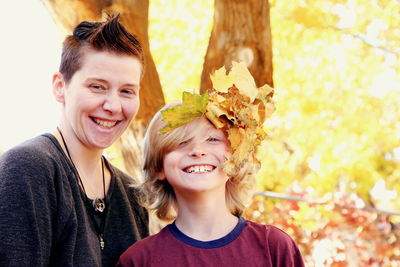 Portrait of happy boy with autumn leaves