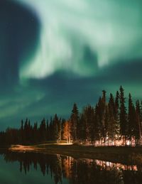 Scenic view of lake against sky at night