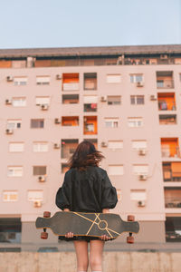 Woman skateboarding in city