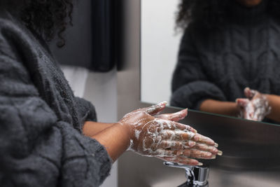 Mid section of woman washing hands