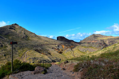 Scenic view of mountains against blue sky