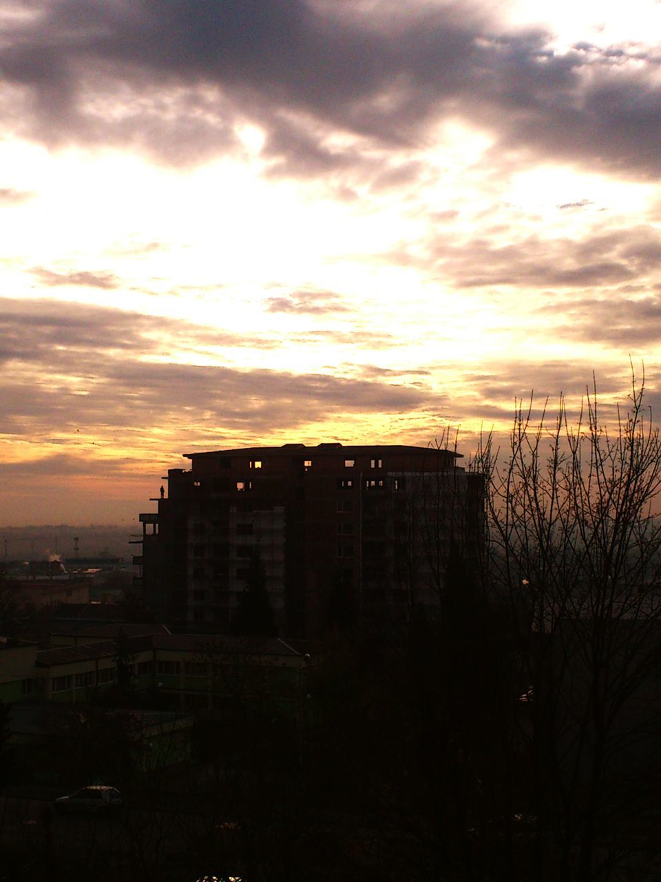 SILHOUETTE OF BUILDINGS AGAINST DRAMATIC SKY