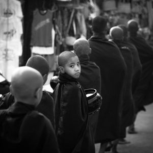 Rear view of monks in queue