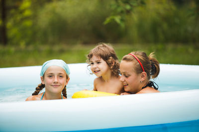 Portrait of a smiling young woman swimming pool