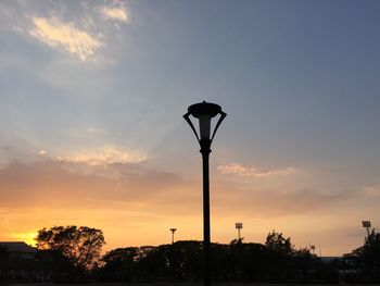 Silhouette street light against sky during sunset