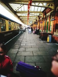 Rear view of woman on train in city