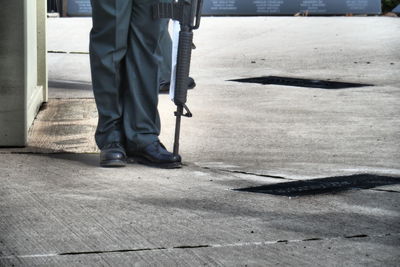 Low section of soldier standing on street