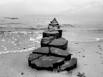 Lifeguard hut on sea shore against sky