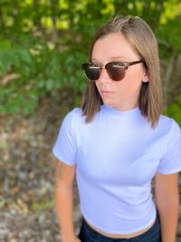 Woman wearing sunglasses standing outdoors