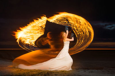 Woman with fire at beach