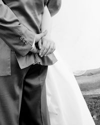Midsection of woman standing against wall
