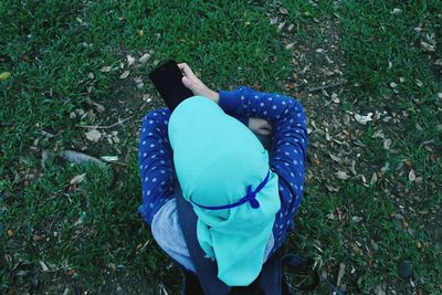 High angle view of man using mobile phone in field