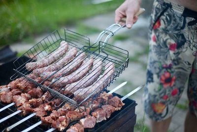 Man preparing food on barbecue grill