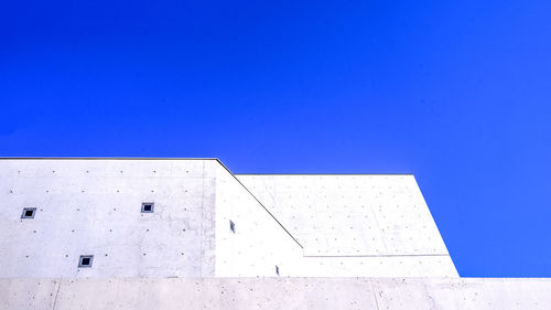 Low angle view of building against clear blue sky