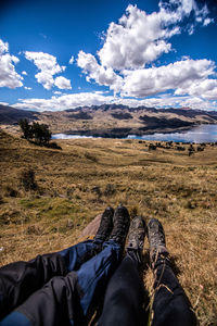 Low section of person relaxing on land