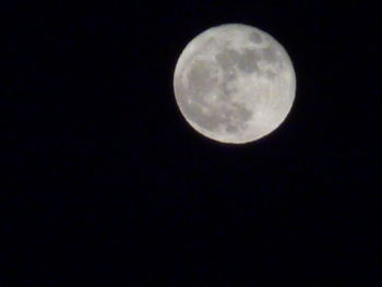 Low angle view of full moon against clear sky at night