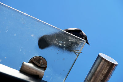 Low angle view of boat against clear blue sky