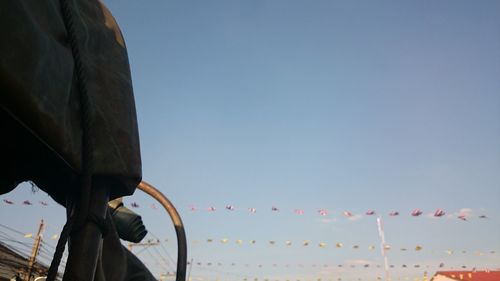 Low angle view of airplane against clear blue sky