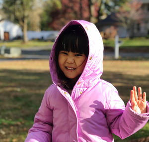 Cute girl wearing hoodie outdoors