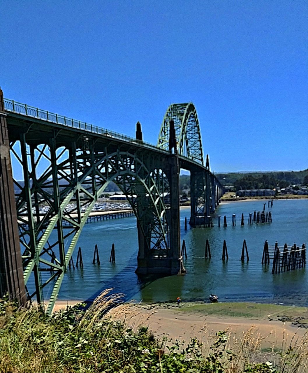VIEW OF BRIDGE OVER RIVER AGAINST CLEAR BLUE SKY
