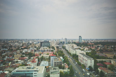 High angle view of city buildings against sky