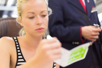 Close-up of beautiful woman sitting in train