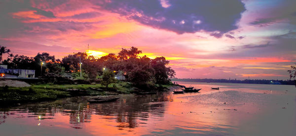 Scenic view of lake against romantic sky at sunset