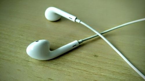 High angle view of headphones on wooden table