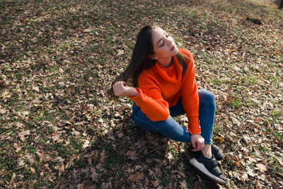 High angle view of teenage girl sitting on land