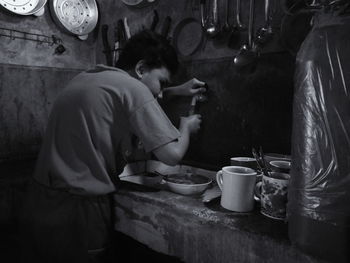 Side view of a man preparing food in restaurant