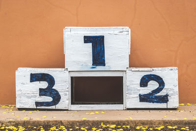 Close-up of winning platform against wall