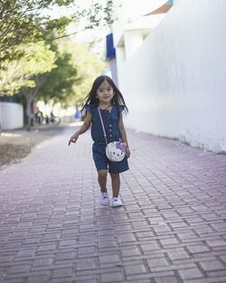 Woman walking on footpath