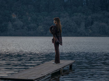 Rear view of woman standing in sea