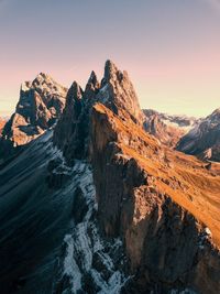 Scenic view of mountains against clear sky during sunset